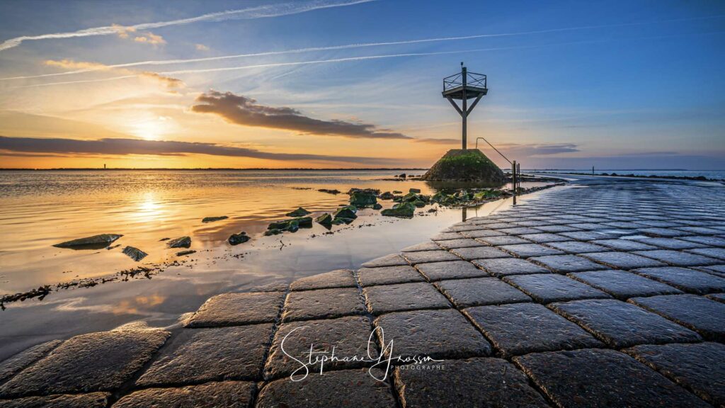 Photographie de coucher de soleil sur le passage du Gois